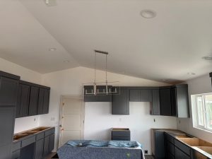 Residential Kitchen Lighting Installation by Cove Electric Modern kitchen remodel with recessed ceiling lights, pendant fixture, and under-cabinet lighting